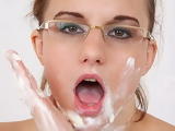 Amateur girl with glasses likes a milk shower