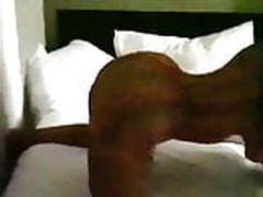 Nicki Minaj twerking on a bed in a transparent dress